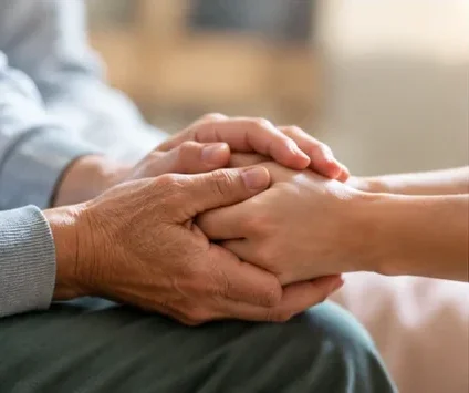 Family member providing emotional support to a cancer patient during recovery